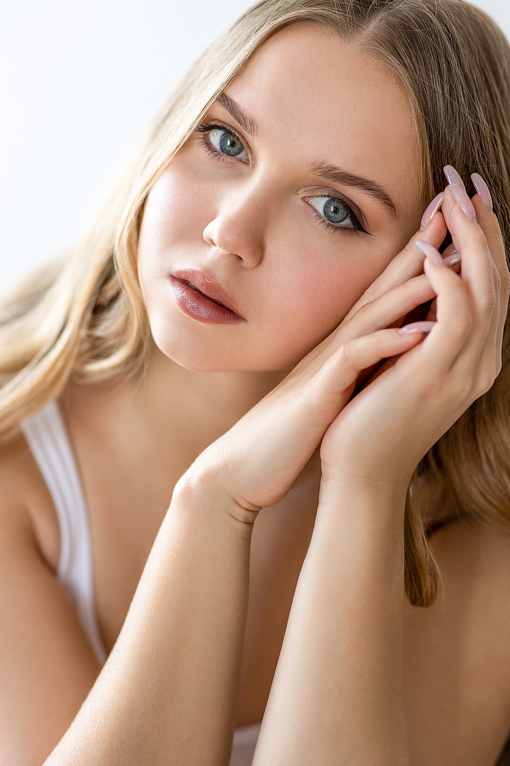 Woman with wet hair looking thoughtfully at camera.